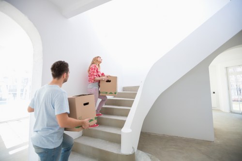 Packed moving boxes and furniture protection prepared for a Knightsbridge home removal